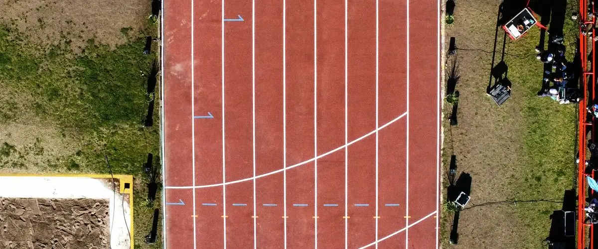 Runner performing a fitness test on an athletics track