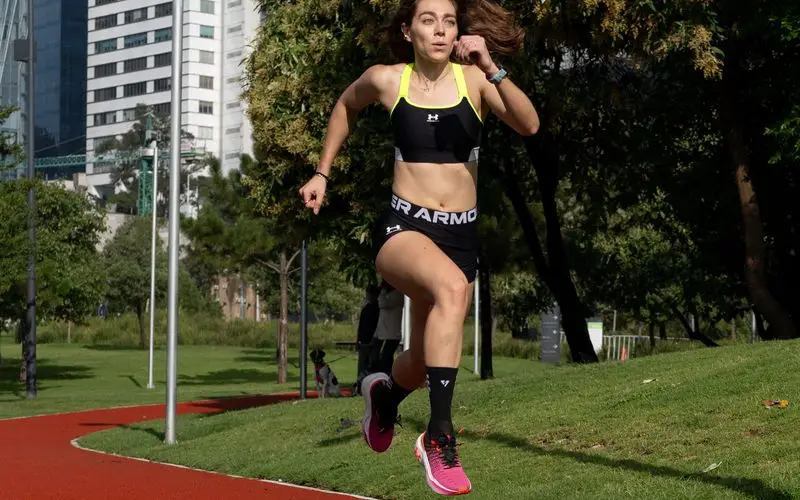 Runner measuring cadence with GPS watch during training