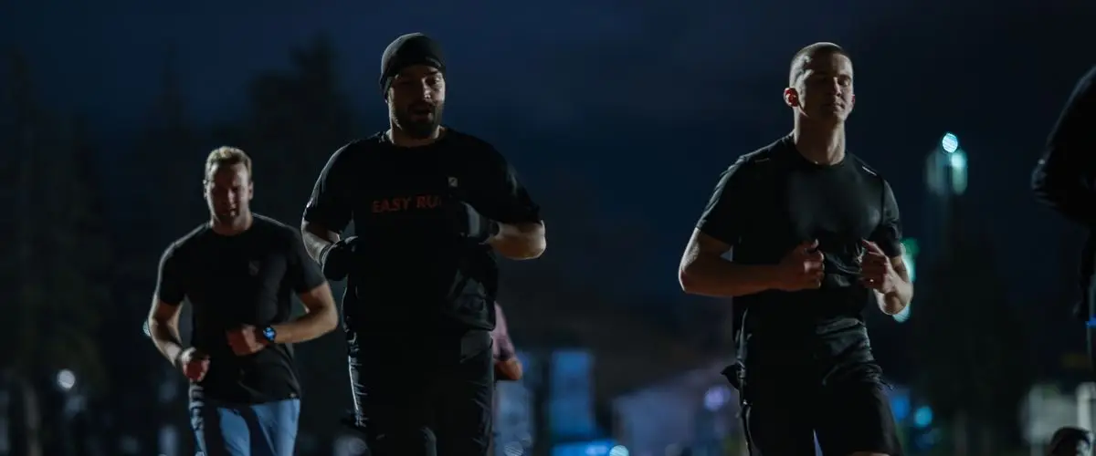 Runners participating in a night race with urban illumination