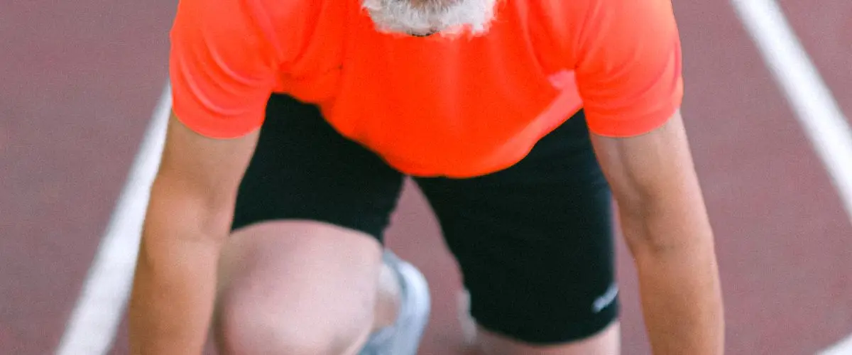 Older adult running outdoors with energy and determination