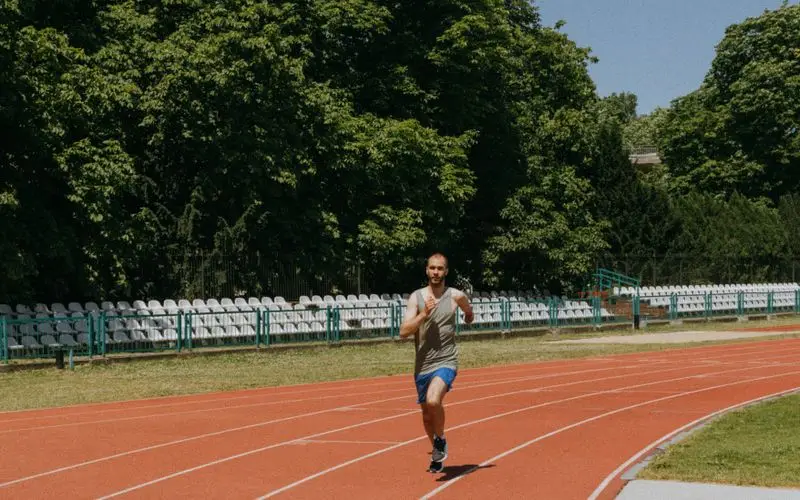 Runner performing endurance test on athletics track